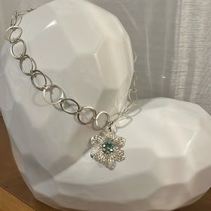 Silver tone circle necklace with flower pendant with aurora borealis blue stones